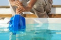 Hotel staff worker cleaning hot tub. Automatic pool cleaners