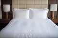 hotel-style bed with crisp white sheets Royalty Free Stock Photo