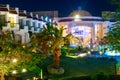 Hotel with a swimming pool and palm trees, Egypt. Night view.