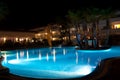 Hotel swimming pool and palms at night Royalty Free Stock Photo