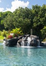 Hotel swimming pool with waterfall Royalty Free Stock Photo