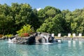 Hotel swimming pool with waterfall Royalty Free Stock Photo