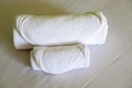 Hotel Towels Roll on the White bed in the Bedroom Royalty Free Stock Photo