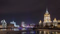 Hotel Ukraine winter night timelapse. Seen as reflected in the Moscow River. Royalty Free Stock Photo