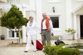 Hotel, vacation and senior walking people with suitcase in a holiday location happy in marriage and retirement together Royalty Free Stock Photo