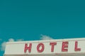 Hotel vintage neon sign text on old building with sky copy space Royalty Free Stock Photo