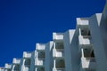 Hotel white balconies view against the blue sky