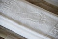 Hotel white clean foot towel folded in bed Royalty Free Stock Photo