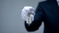 Hotel word on keychain in receptionist hand, room reservation, luxury services