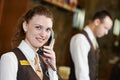 Hotel worker with phone on reception Royalty Free Stock Photo