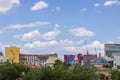 hotels and tower cranes in the city skyline with lush green trees and blue sky and clouds at the Bellagio Hotel in Las Vegas