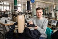 hoto of a young man working with linking machine for knitting in textile industry