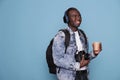hotography enthusiast having DSLR device and wireless headphones going on citybreak vacation. Royalty Free Stock Photo