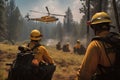 hotshot crew preparing to battle raging wildfire, with helicopter providing air support Royalty Free Stock Photo