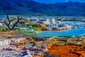 Hotsprings with multiple colors and blue mountains in the background