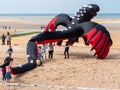 Houlgate, France, May 2023 dragon - a huge kite in the shape of a dragon children helping the dragon to fly at the Houlgaten kite