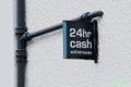 24 hour cash withdrawals sign on wall above ATM machine Royalty Free Stock Photo