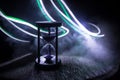 Hourglass as time passing concept for business deadline, urgency and running out of time. Sandglass, egg timer on dark background Royalty Free Stock Photo