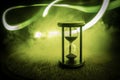 Hourglass as time passing concept for business deadline, urgency and running out of time. Sandglass, egg timer on dark background Royalty Free Stock Photo