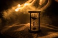 Hourglass as time passing concept for business deadline, urgency and running out of time. Sandglass, egg timer on dark background Royalty Free Stock Photo