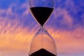 Hourglass on the background of a sunset sky. The value of time in life. An eternity Royalty Free Stock Photo