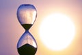 Hourglass on the background of a sunset sky. The value of time in life. An eternity Royalty Free Stock Photo