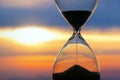 Hourglass on the background of a sunset. The value of time in life. An eternity Royalty Free Stock Photo