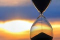 Hourglass on the background of a sunset. The value of time in life. An eternity Royalty Free Stock Photo