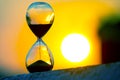 Hourglass on the background of a sunset. The value of time in life. An eternity Royalty Free Stock Photo