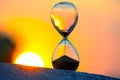 Hourglass on the background of a sunset. The value of time in life. An eternity Royalty Free Stock Photo