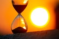 Hourglass on the background of a sunset. The value of time in life. An eternity Royalty Free Stock Photo