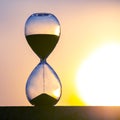 Hourglass on the background of a sunset. The value of time in life. An eternity Royalty Free Stock Photo