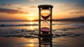 Hourglass on the beach with evening sunlight before sunset