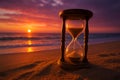 Hourglass on a beach at sunset, symbolizing the passage of time and the beauty of fleeting moments by the ocean Royalty Free Stock Photo