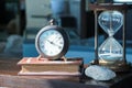 An hourglass, clock and books for decoration