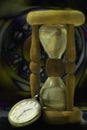 Hourglass and clock. Night time