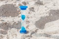 Hourglass close-up stand on white beach sand background Royalty Free Stock Photo