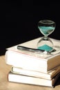 Hourglass countdown with books and a pen Royalty Free Stock Photo