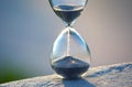 Hourglass counts the length of time against. The concept of the fluidity of life time in the universe. time and light Royalty Free Stock Photo
