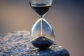 Hourglass counts the length of time against. The concept of the fluidity of life time in the universe. time and light Royalty Free Stock Photo