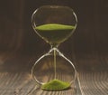 Hourglass on dark background, vintage wooden and color tone Royalty Free Stock Photo