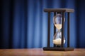 Hourglass on a dark blue background Royalty Free Stock Photo