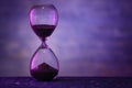 Hourglass on dark color background. Time management concept