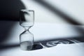 Hourglass on the desk Striking light, shadow and glass reflections Royalty Free Stock Photo
