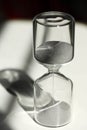 Hourglass on the desk Striking light, shadow and glass reflections Royalty Free Stock Photo