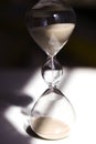 Hourglass on the desk Striking light, shadow and glass reflections Royalty Free Stock Photo