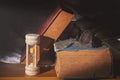 Hourglass and eyeglasses with antique books.