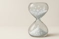 An hourglass with falling snow instead of sand. Space for text. Royalty Free Stock Photo
