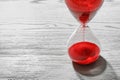 Hourglass with flowing red sand Royalty Free Stock Photo