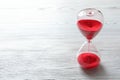 Hourglass with flowing red sand Royalty Free Stock Photo